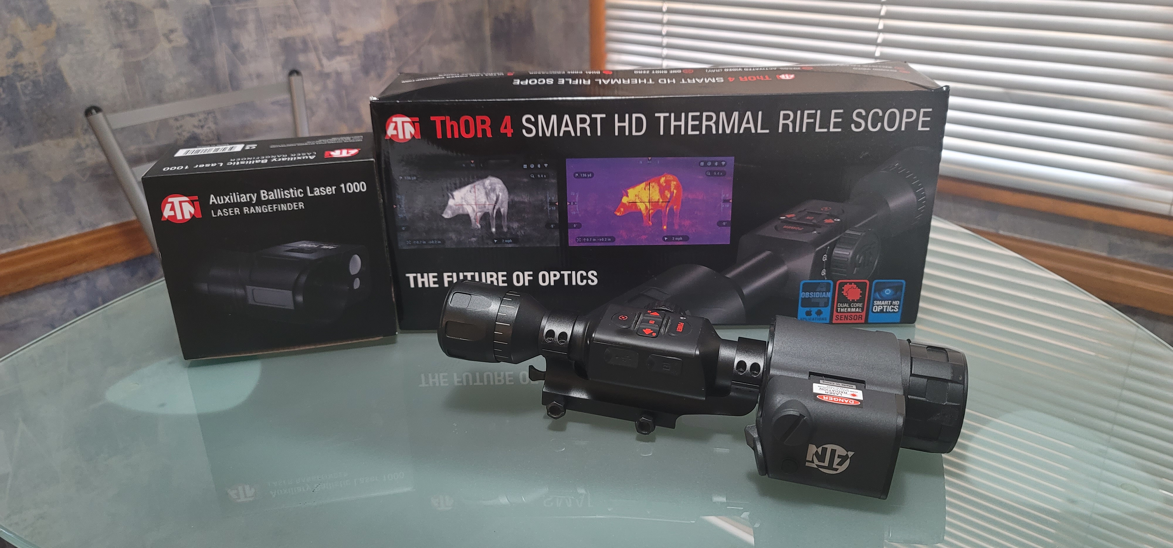 ATN ThOR 4 384 thermal riflescope mounted on a bolt-action rifle at dusk