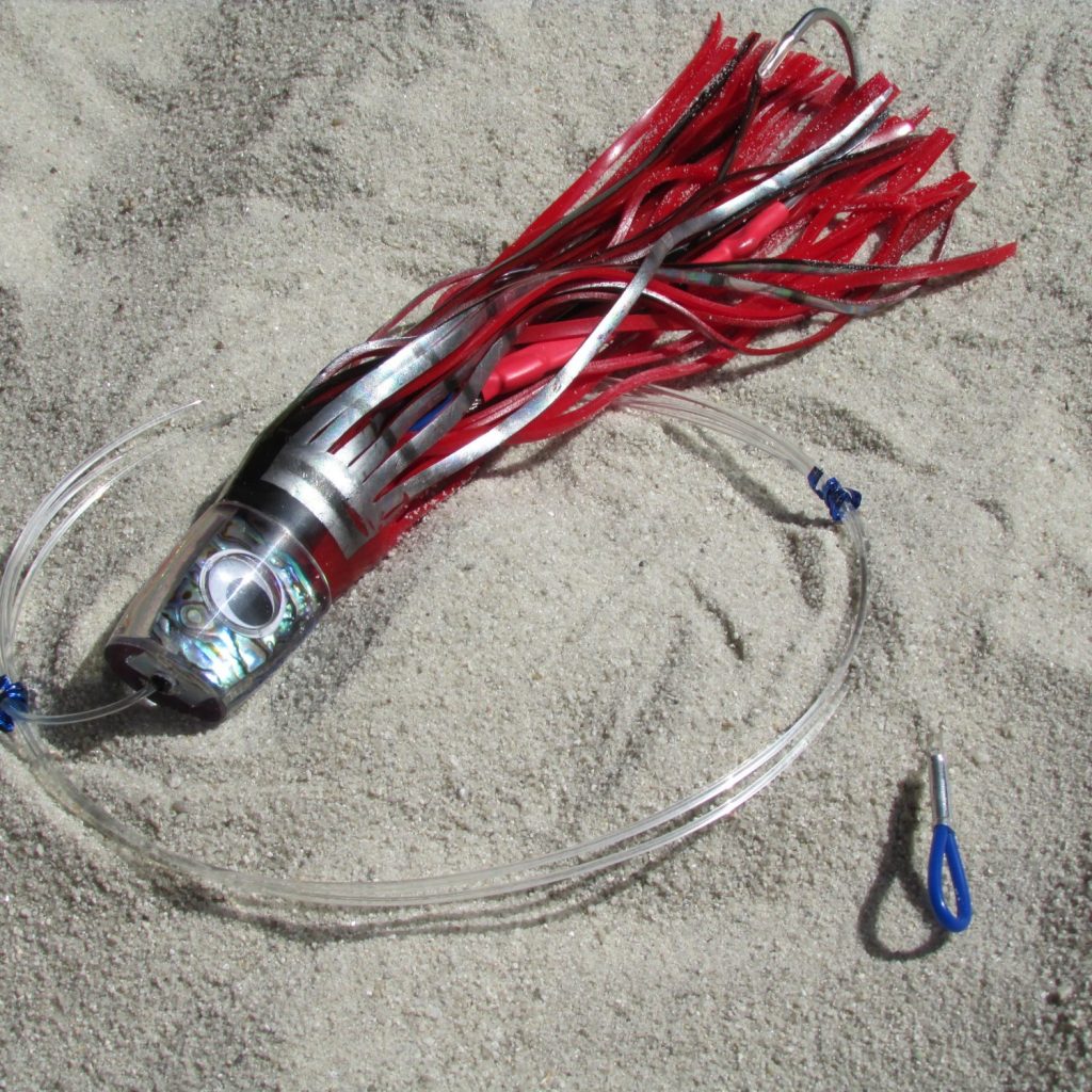 Colorful trolling lures and skirted jigs arranged on a tackle board