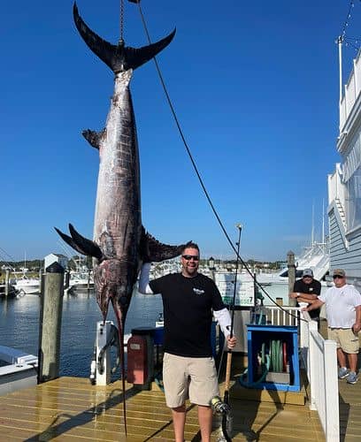 Angler fighting a broadbill swordfish on heavy tackle from an offshore boat