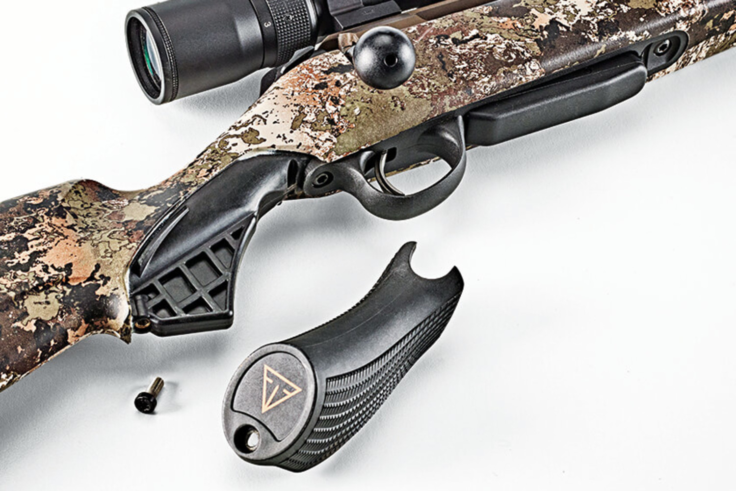 Tikka T3x Lite bolt-action rifle on a shooting bench with mountain backdrop
